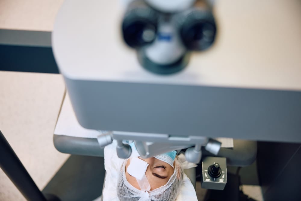 Close-up of a patient undergoing LASIK eye surgery, showing advanced ophthalmic equipment and sterile conditions during the procedure.
